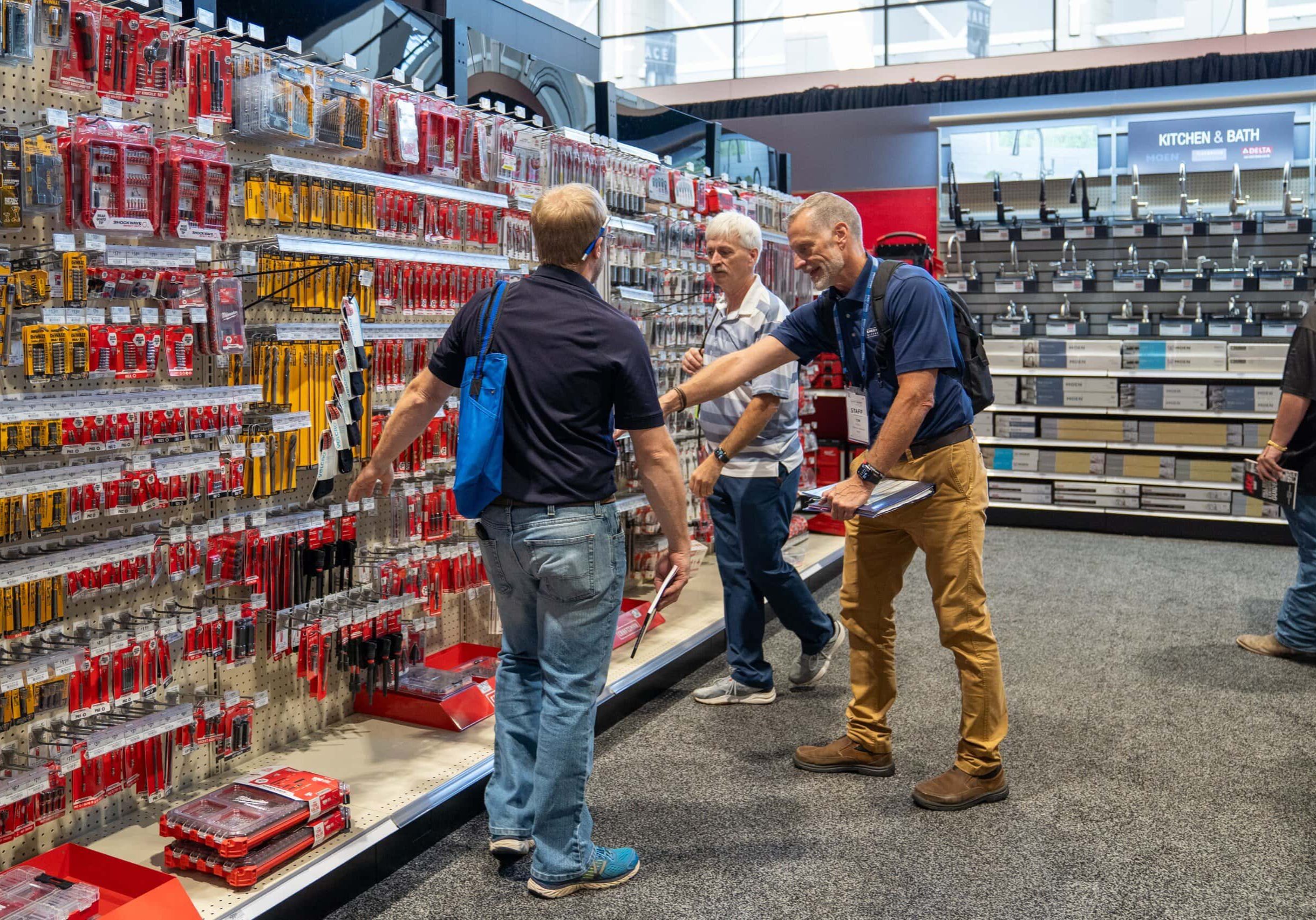 Men shopping for tools in hardware store.