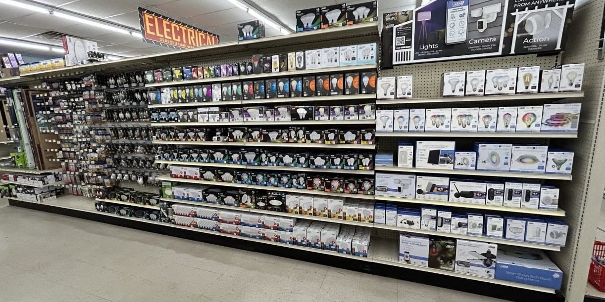 Store aisle with various light bulbs on shelves.