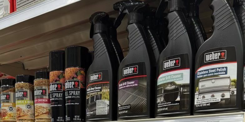 Weber grill cleaning supplies on store shelf.